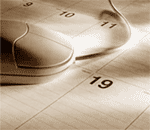 Photograph of a computer mouse on a desk calendar.